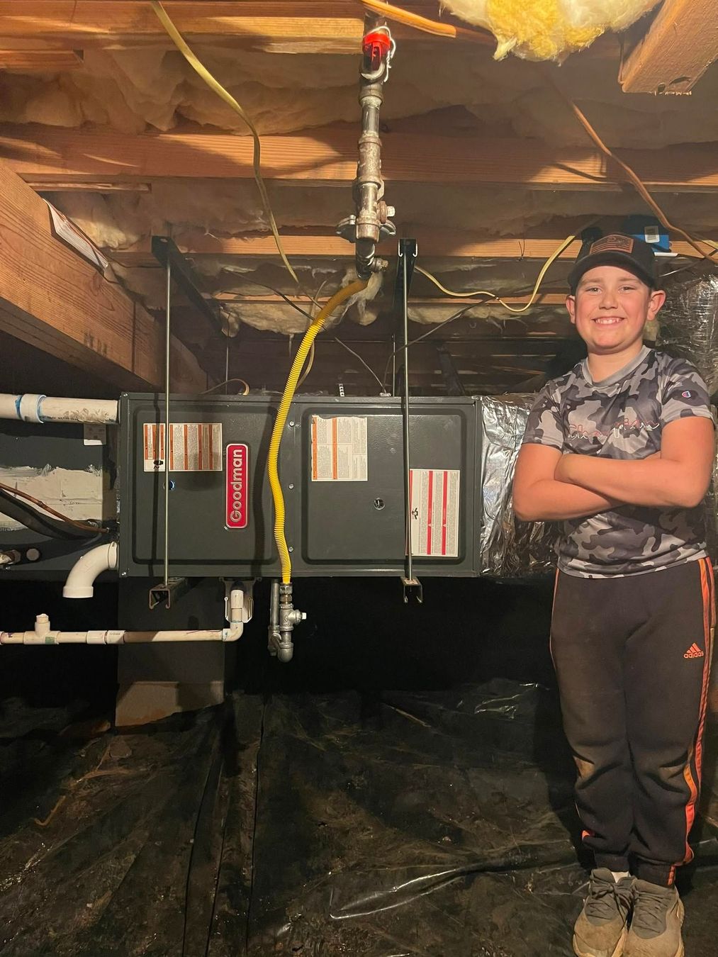 Davis and Sons HVAC technician inspecting crawlspace HVAC system