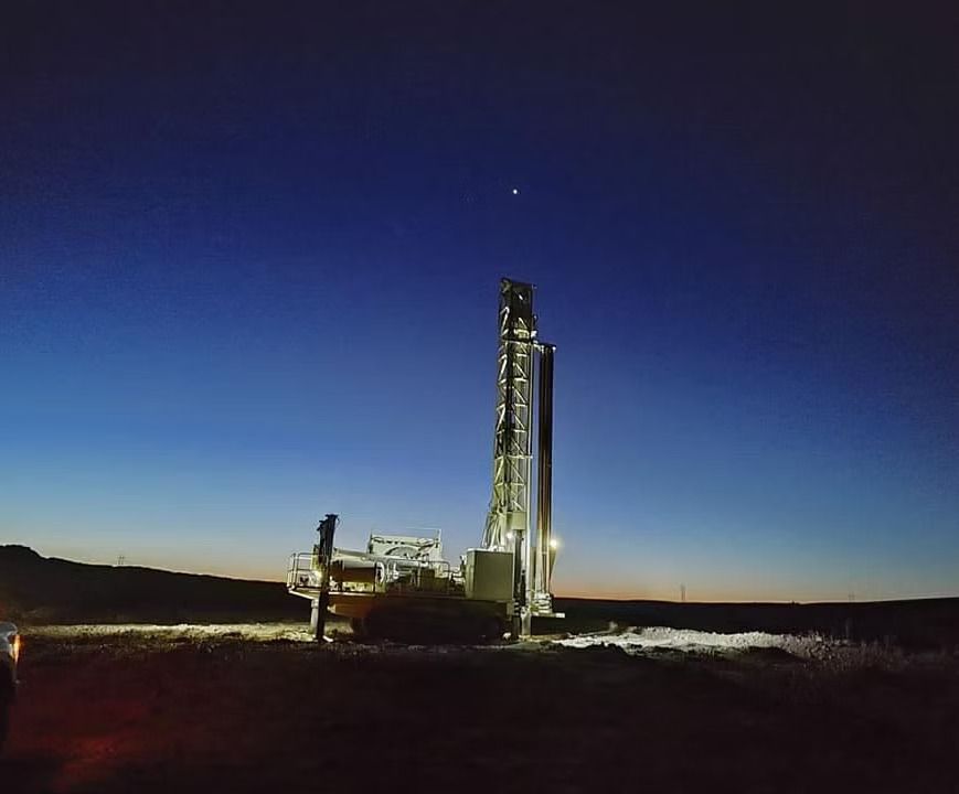 Rocket on a launch pad at dusk under a deep blue sky