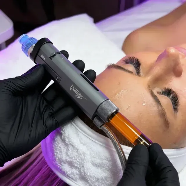 Aesthetic treatment with a facial device applied to a client's forehead in a spa setting