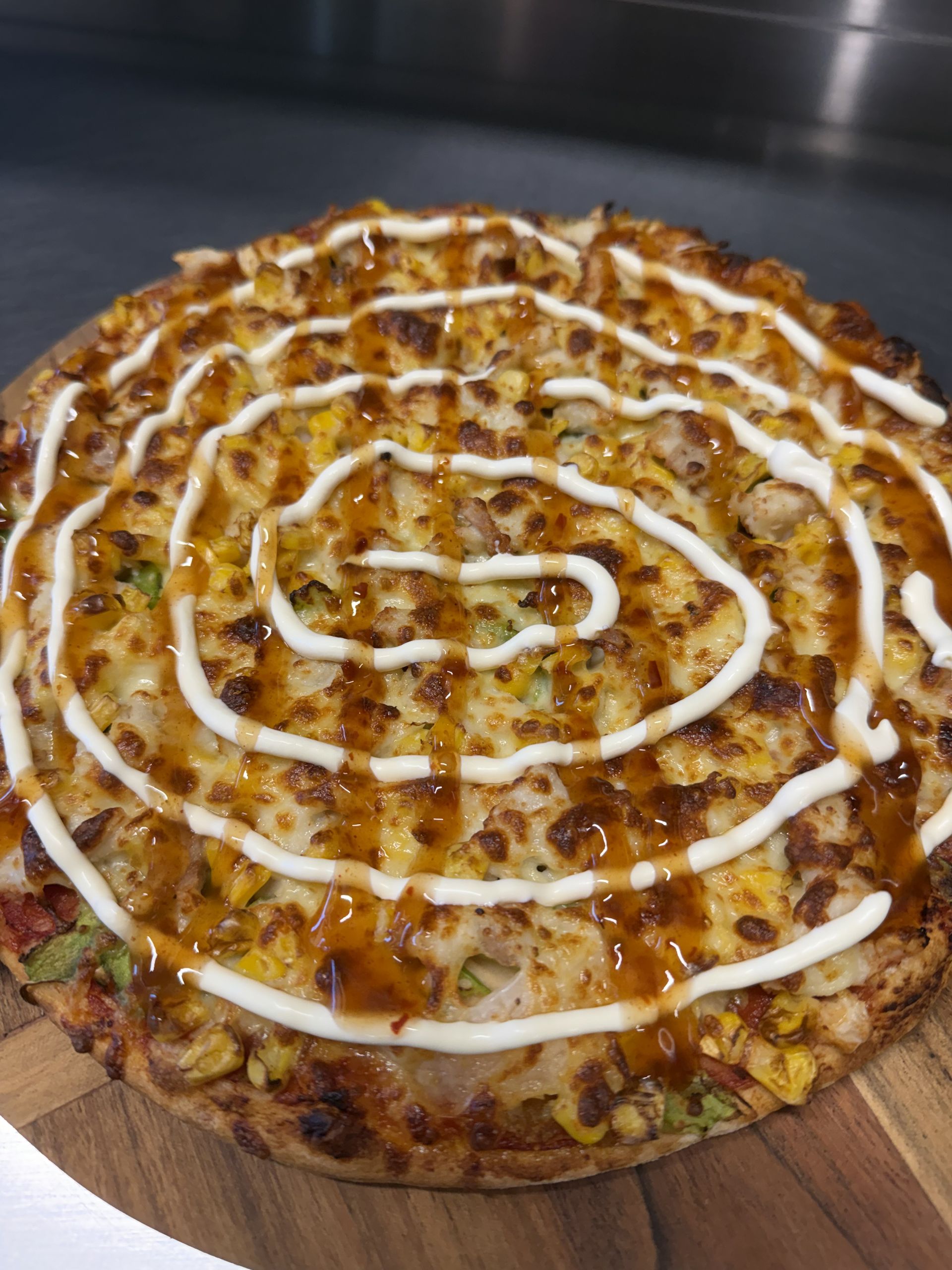 A Pizza With A Lot Of Toppings On It Is On A Red Plate — Bel-Air Pizza In Port Macquarie, NSW