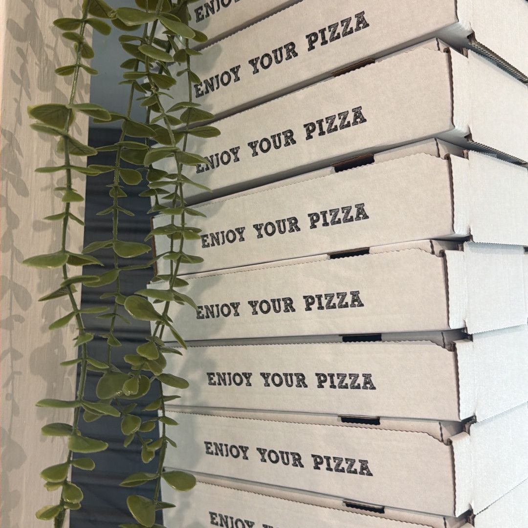 A Pizza With Shrimp, Pineapple, Olives And Cheese Is Sitting On A Pizza Pan On A Grill — Bel-Air Pizza In Port Macquarie, NSW