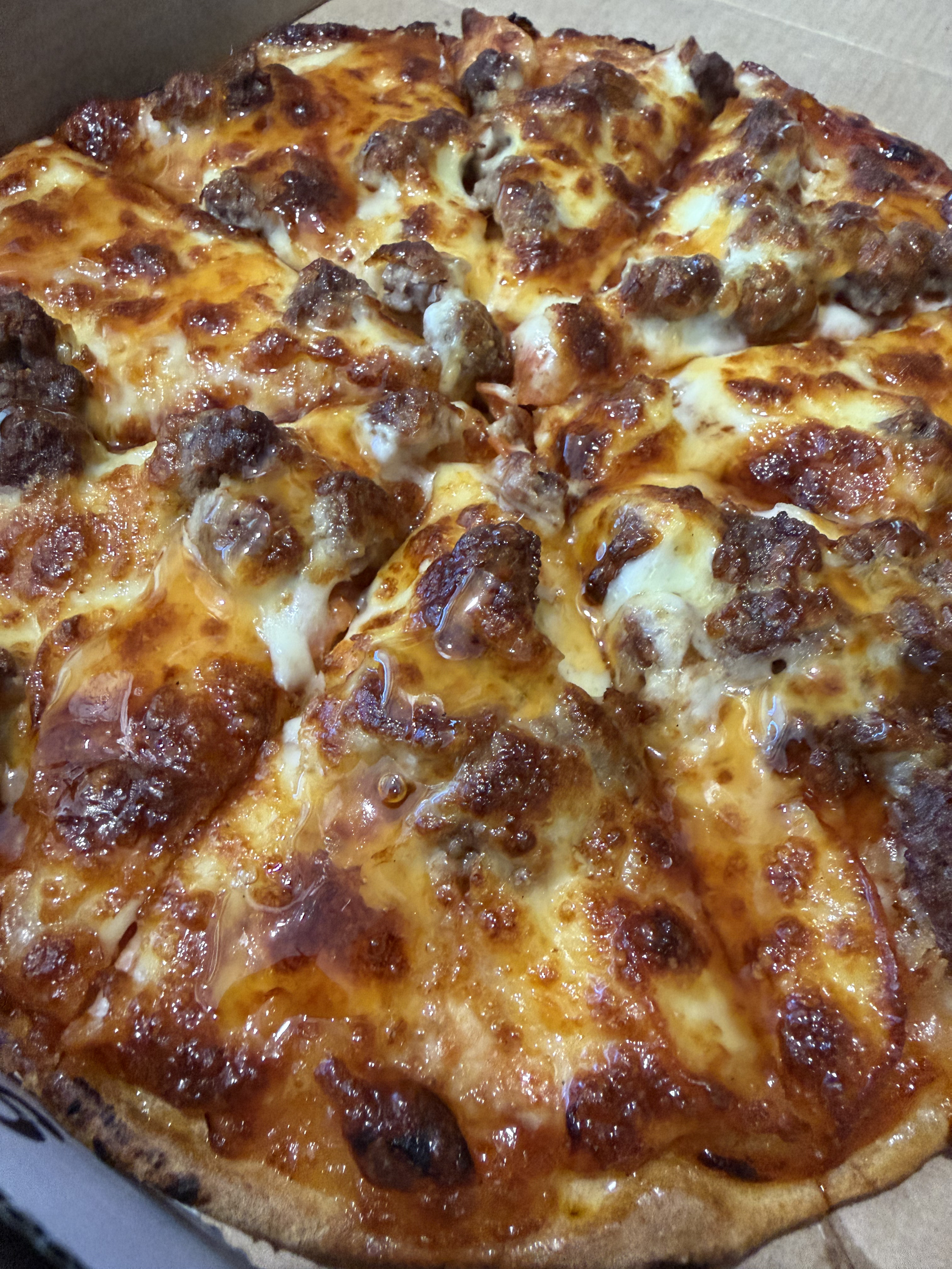 A Pizza Is Sitting On A Wire Rack In A Pizza Oven — Bel-Air Pizza In Port Macquarie, NSW
