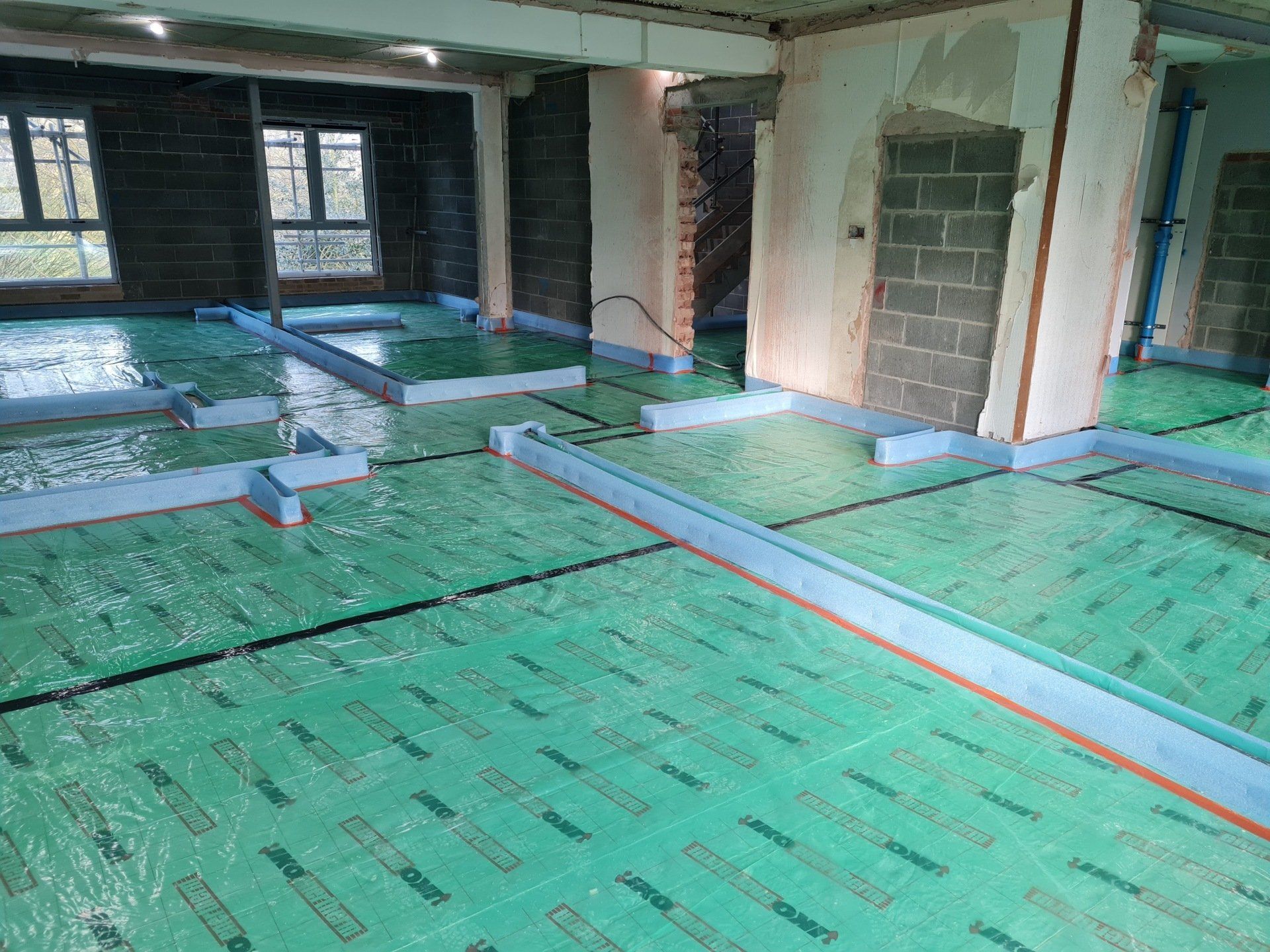 Floor prepared with sound proofing and insulation, ready for the liquid screed installation in Cambridge.