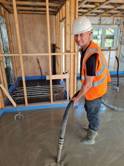 John, one of Superflow Screeds installers. Pictured here installing a liquid screed.