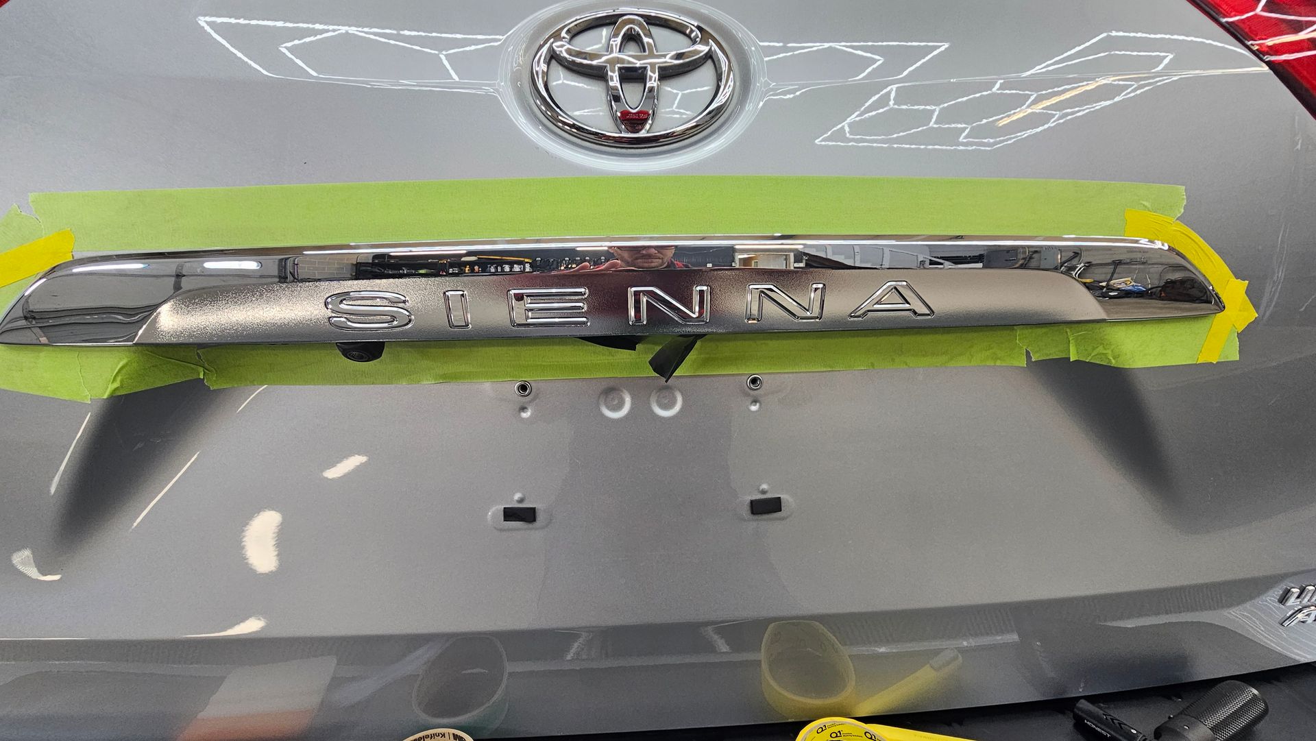 Front grille of a silver Toyota car with “INNOVA” badge, outlined in yellow.