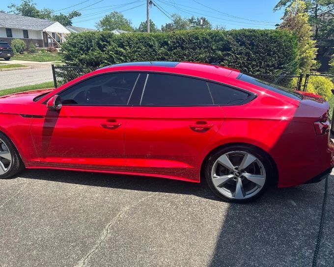 Red Audi A5 Sportback with professionally applied window tinting and added privacy
