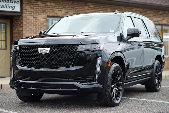 Black Cadillac Escalade with PPF (paint protection film) parked in a lot