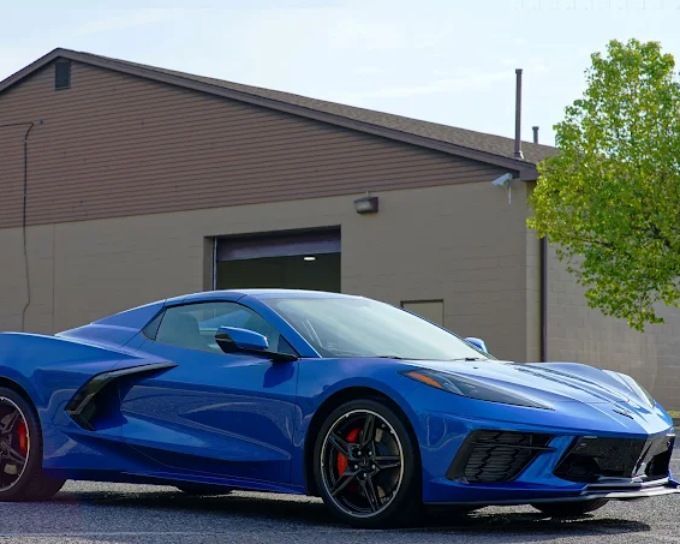 Blue Chevrolet Corvette C8 with a deep gloss ceramic coating finish, illustrating professional vs. DIY ceramic coating quality