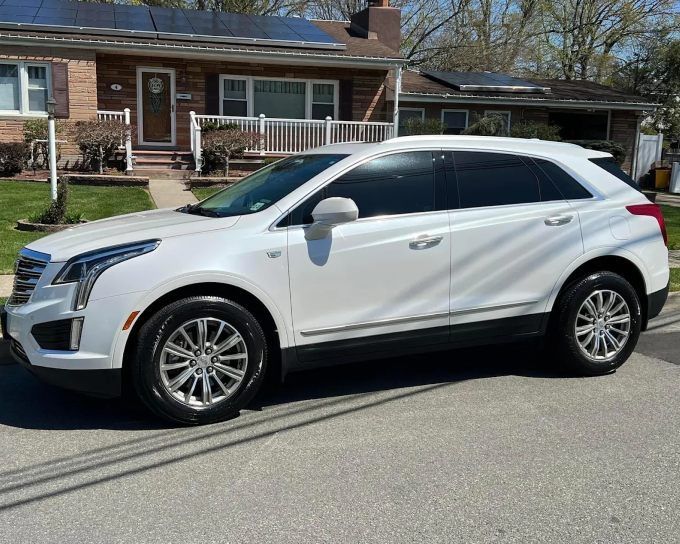 White Cadillac XT5 SUV with professional window tinting for heat and UV protection