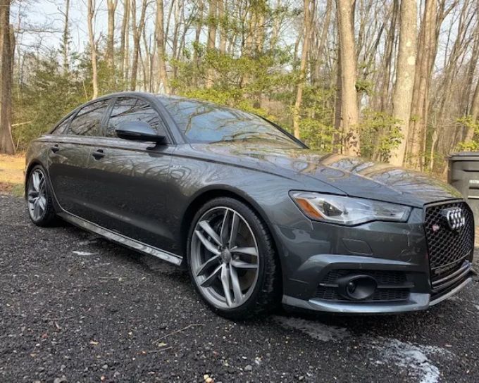 Gray luxury sedan with a glossy finish protected by professional ceramic coating.