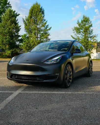 Matte black Tesla Model Y with PPF (paint protection film) parked outdoors
