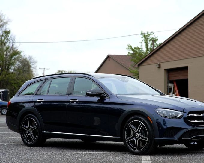 Dark blue Mercedes-Benz E-Class All-Terrain wagon parked outside after professional window tinting