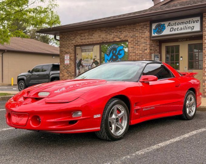 Red Pontiac Firebird Trans Am outside M&G Automotive Detailing after a ceramic coating
