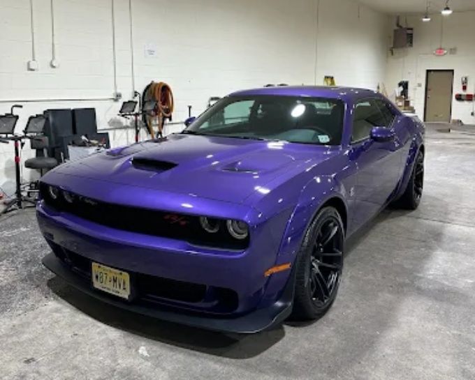 Purple Dodge Challenger with professional window tint and custom automotive detailing.