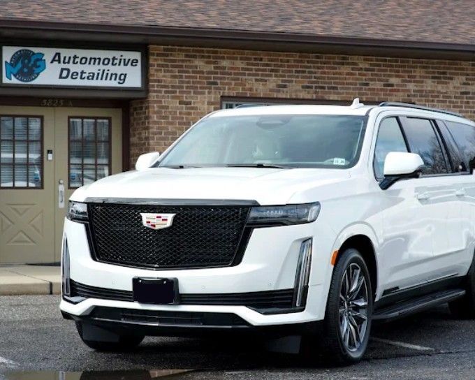White Cadillac Escalade outside M&G Automotive Detailing after a professional vs. DIY ceramic coating treatment