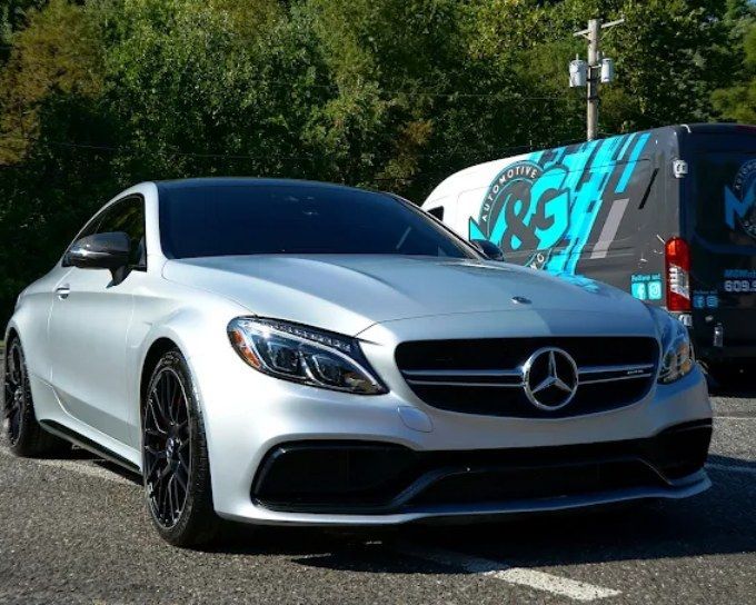 White Mercedes-Benz coupe with a high-gloss ceramic-coated finish showing professional vs. DIY ceramic coating quality