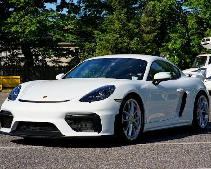 White Porsche 718 Cayman with tinted windows showcasing professional window tint for heat rejection
