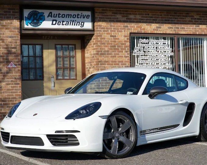 Porsche parked outside M&G Automotive Detailing after professional window tint for heat rejection