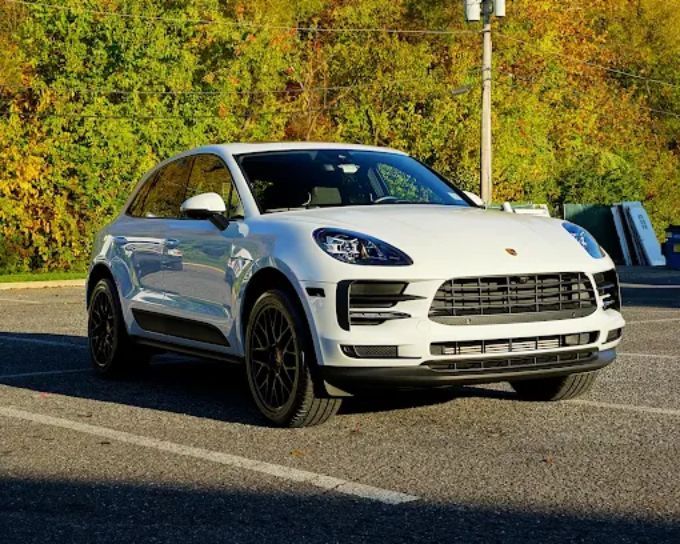 White Porsche Macan SUV with darkened windows demonstrating window tint for heat rejection and UV protection

