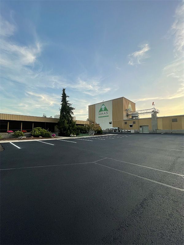 A large building with a parking lot in front of it.