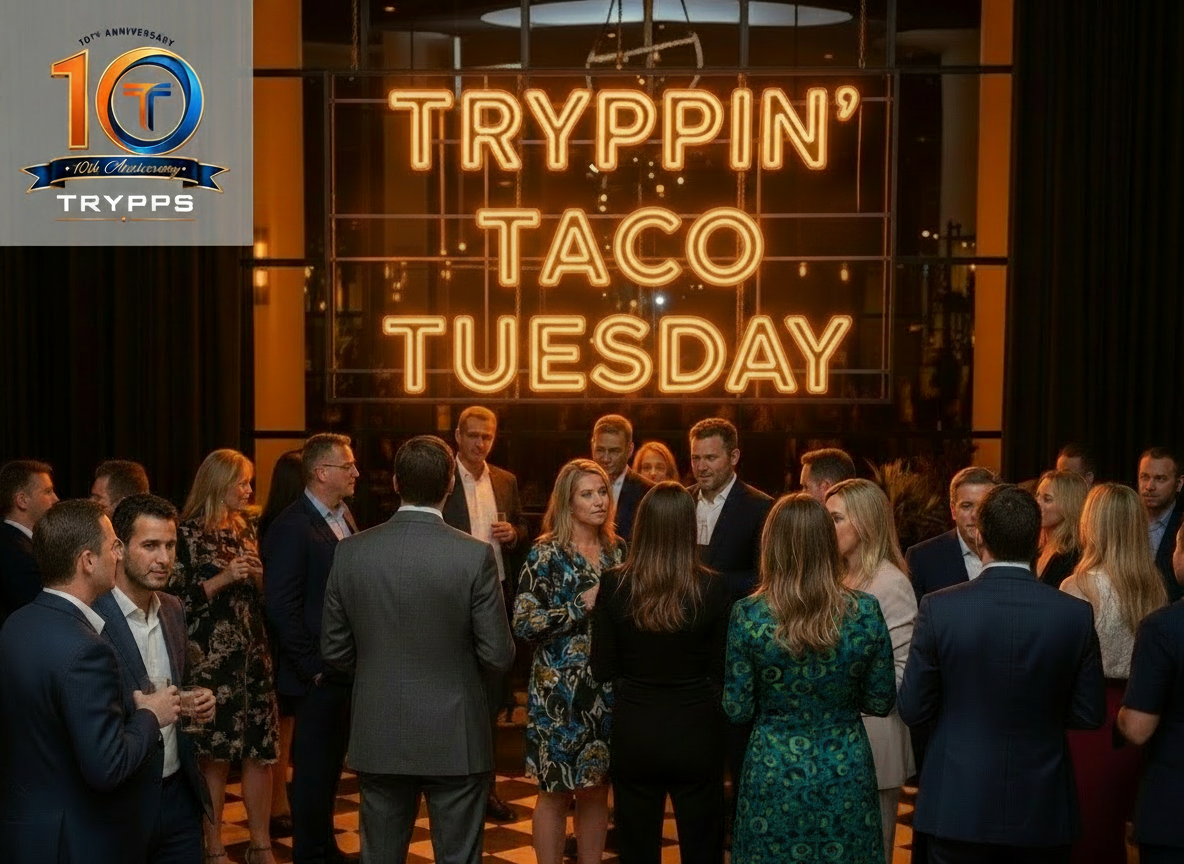 Crowd mingling at a party beneath a neon sign reading “Tryppin’ Taco Tuesday”