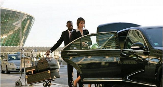 A man and a woman are getting into a car.