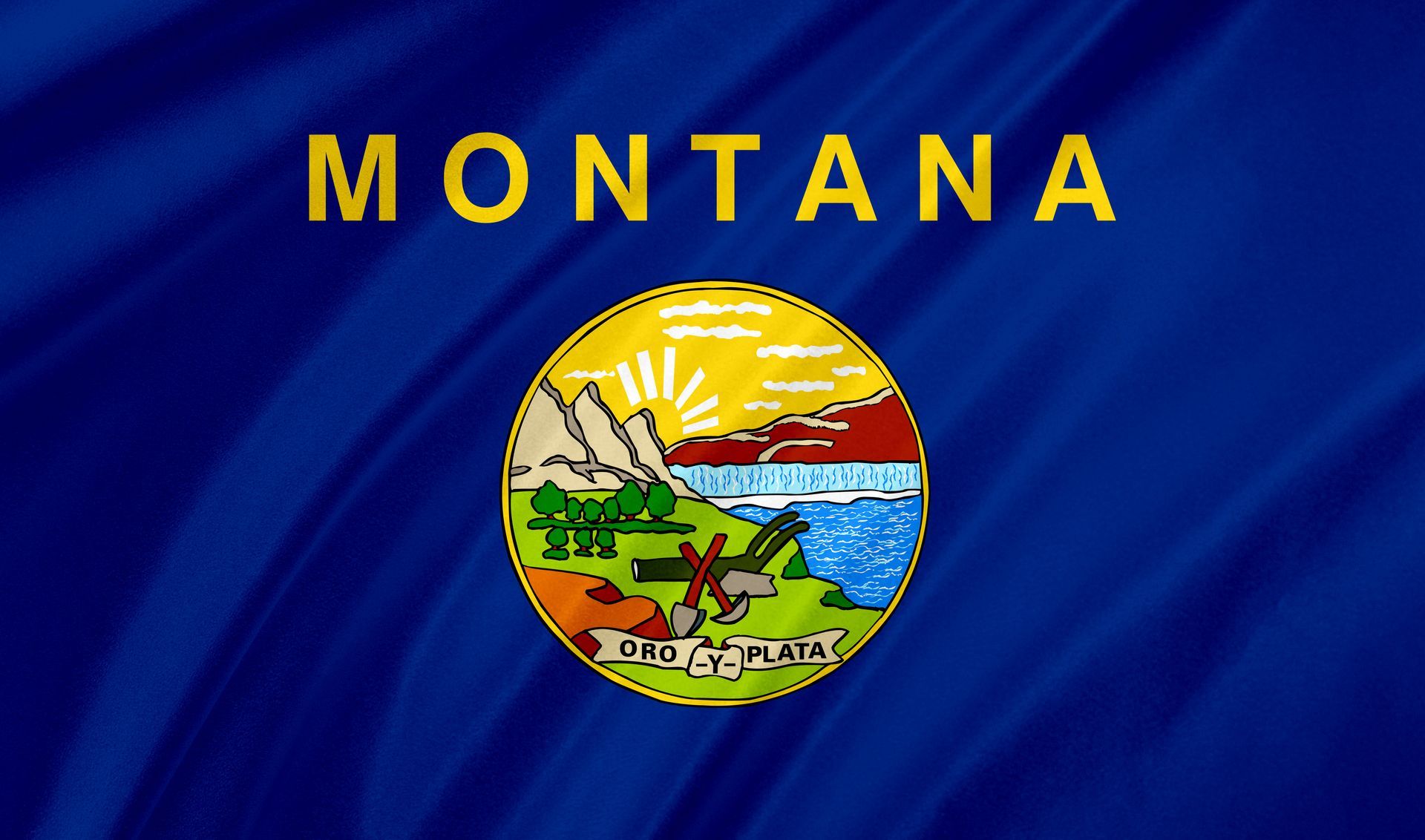 Montana state flag with blue field, the word “MONTANA,” and the state seal at center