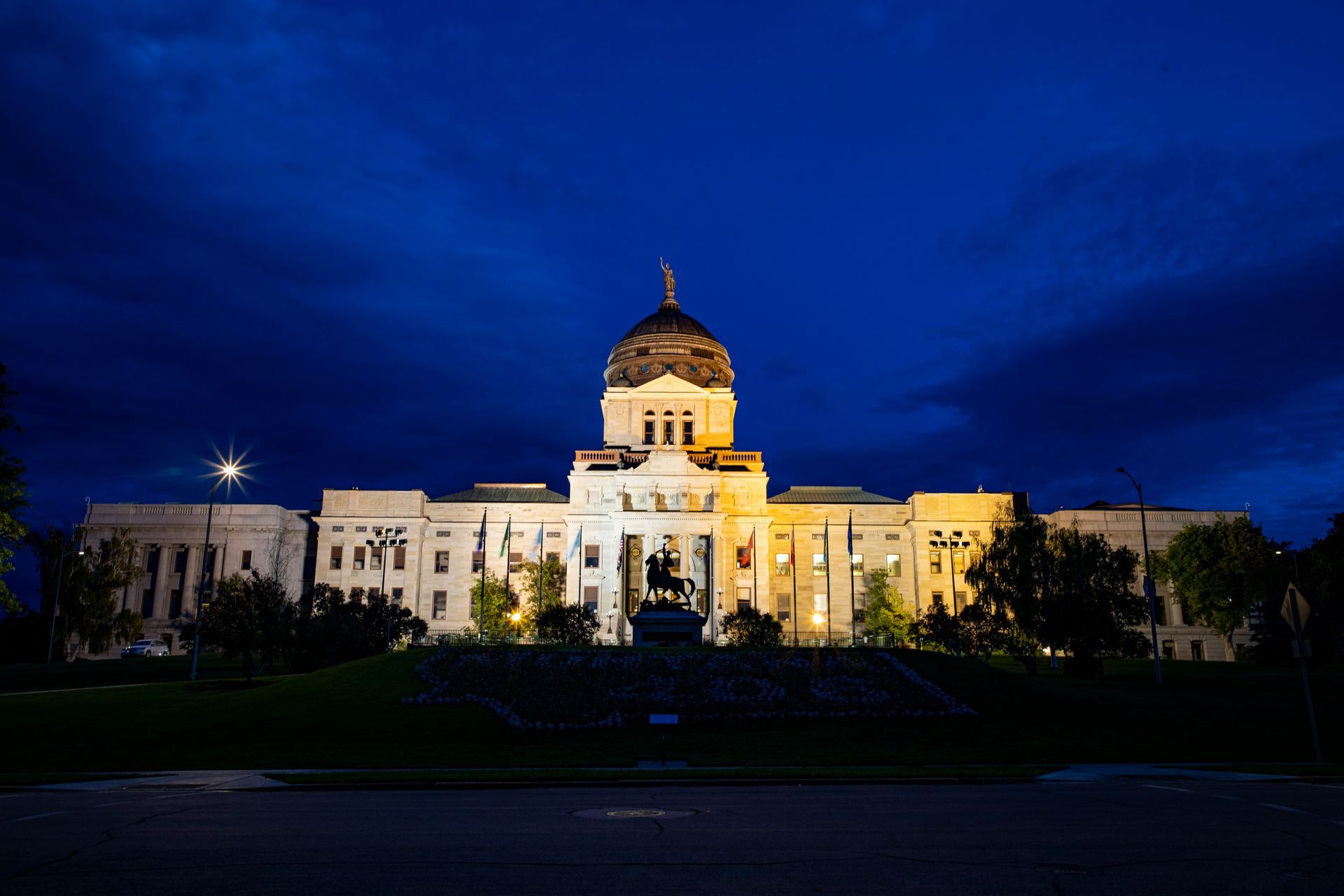 Illuminated capitol building at night under a deep blue sky