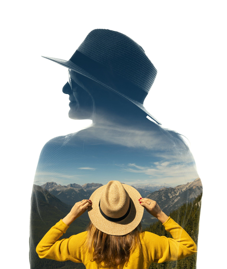 Silhouette double exposure of a hiker in a hat overlooking mountains at sunset