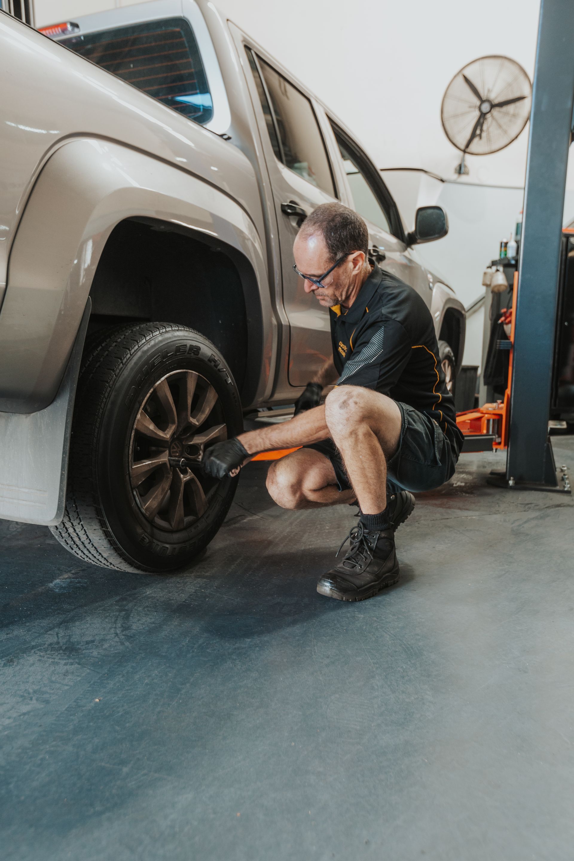 A Man is Looking Under the Hood of a Car While Using a Tablet — Varsity Lakes Mechanical Repairs In Varsity Lakes, QLD