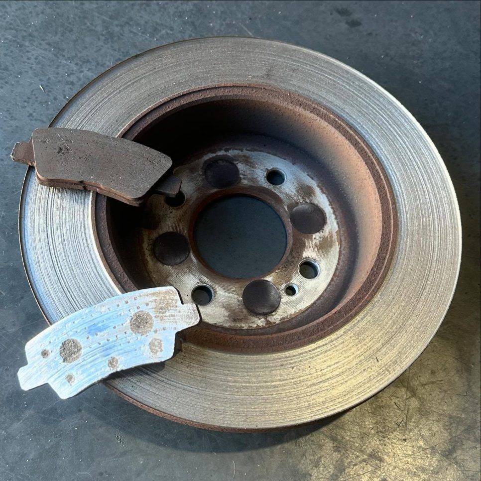 A Brake Disc With a Broken Brake Pad on It — Varsity Lakes Mechanical Repairs In Varsity Lakes, QLD
