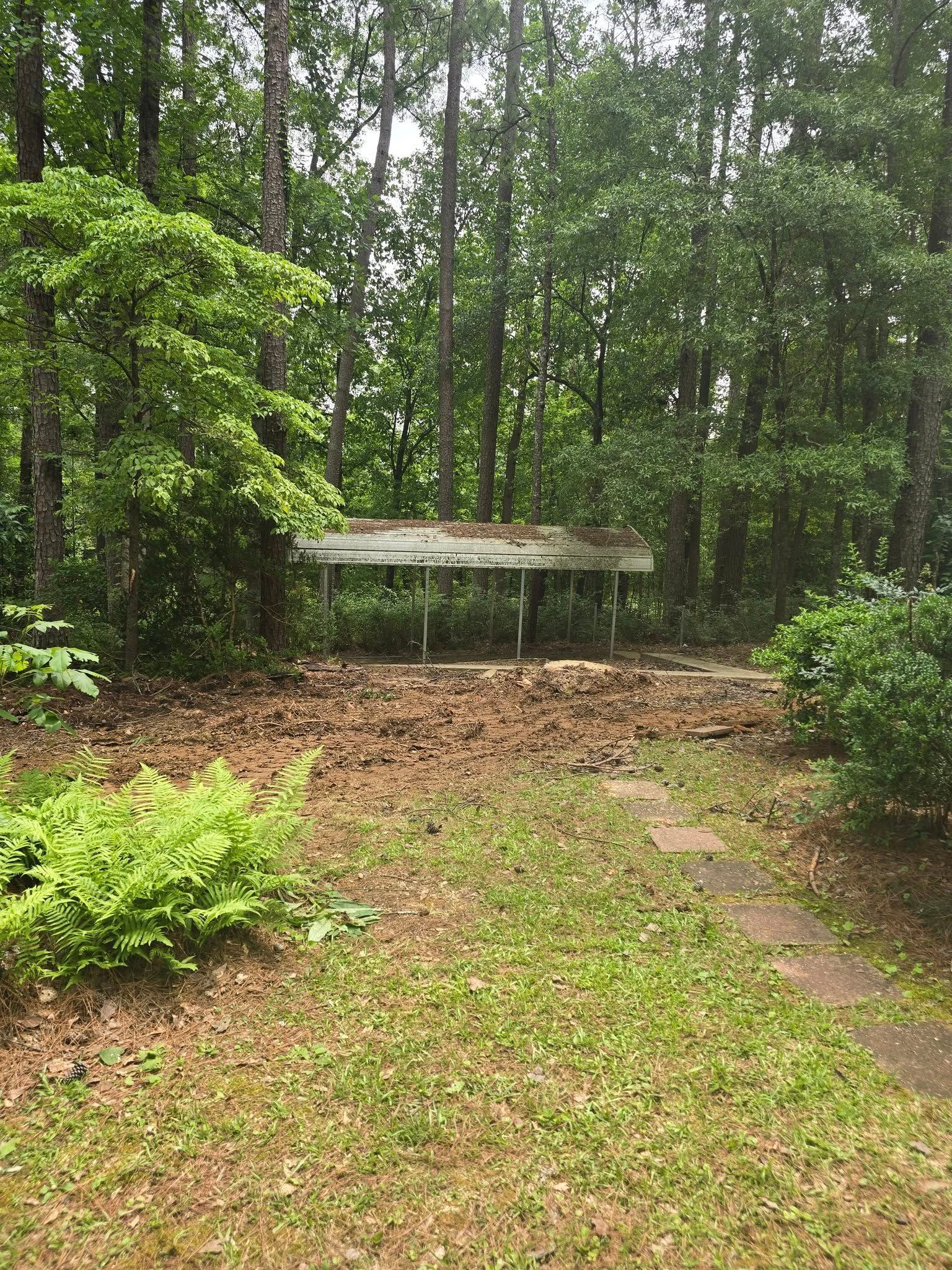 There is a covered area in the middle of the woods.