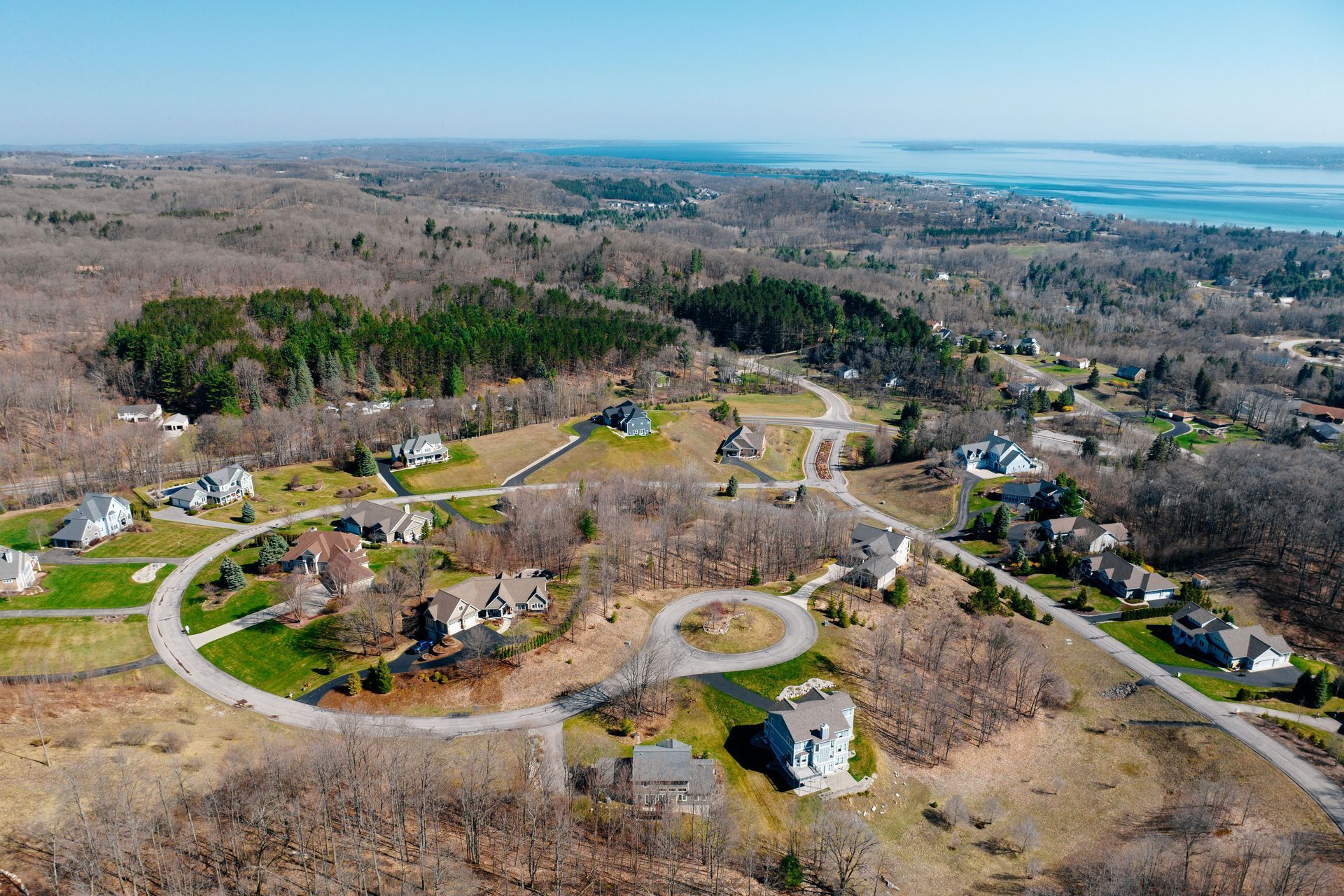 An aerial view of a residential area with a lake in the background.