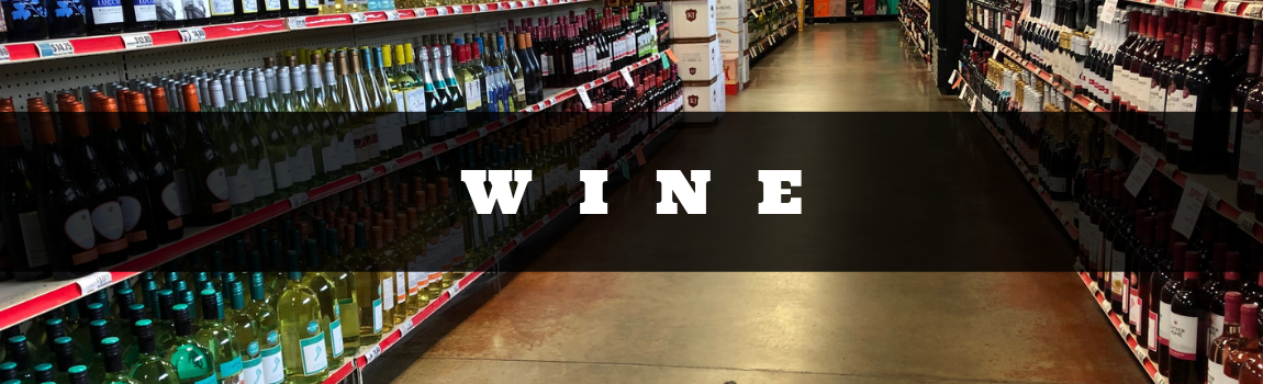 Wine bottles lined on shelves with a central aisle and the word “WINE” across the middle.