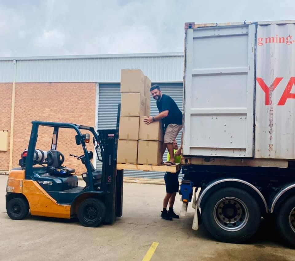 Man is Loading Boxes Onto a Ya Truck — Grants Express in Smithfield, NSW