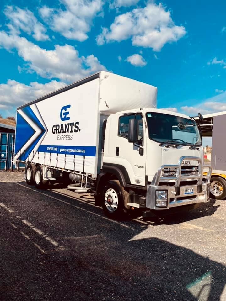 White and Blue Truck is Parked in a Parking Lot — Grants Express in Ingleburn, NSW