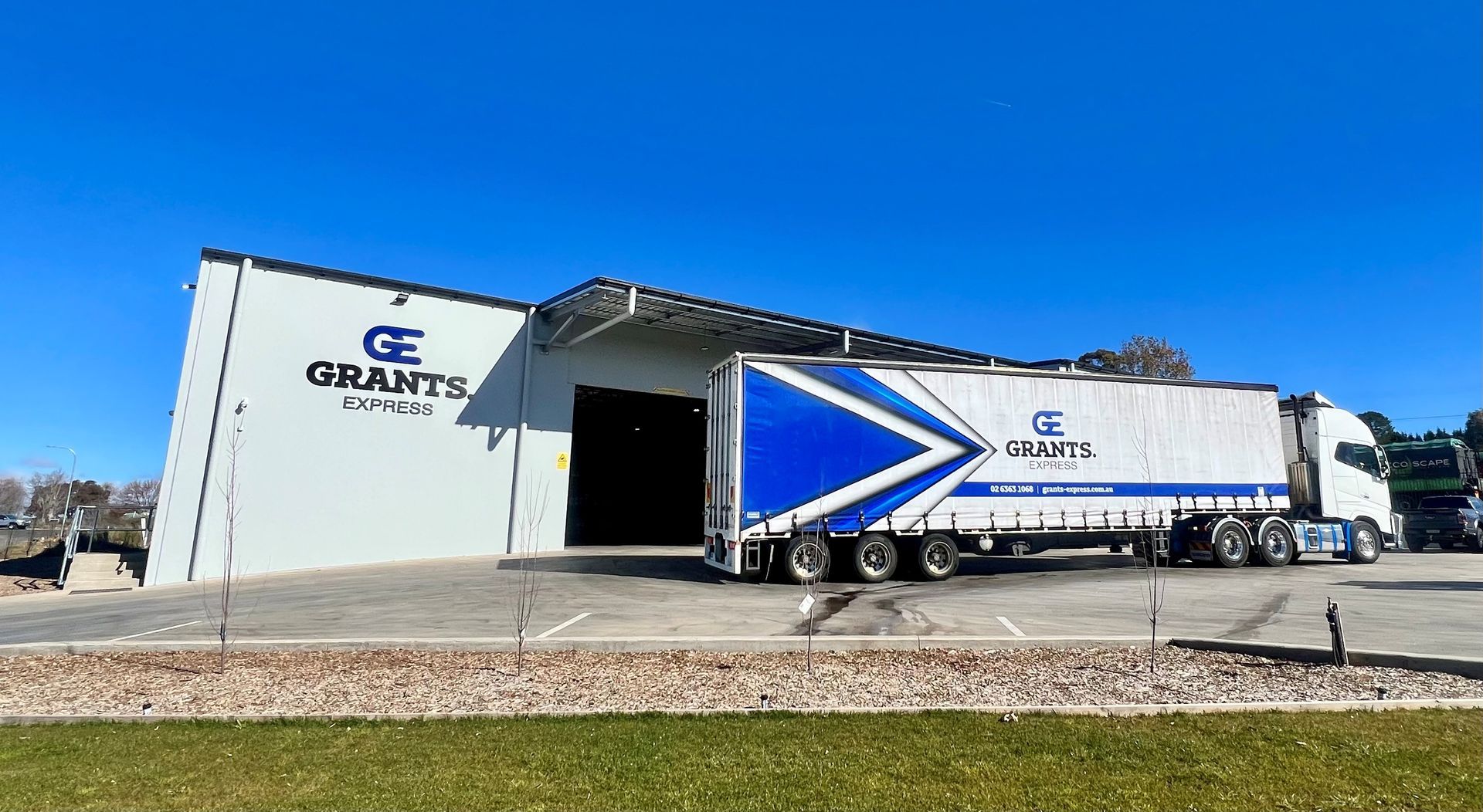 Large Building With a Blue Truck Parked in Front of It — Grants Express in Sydney, NSW