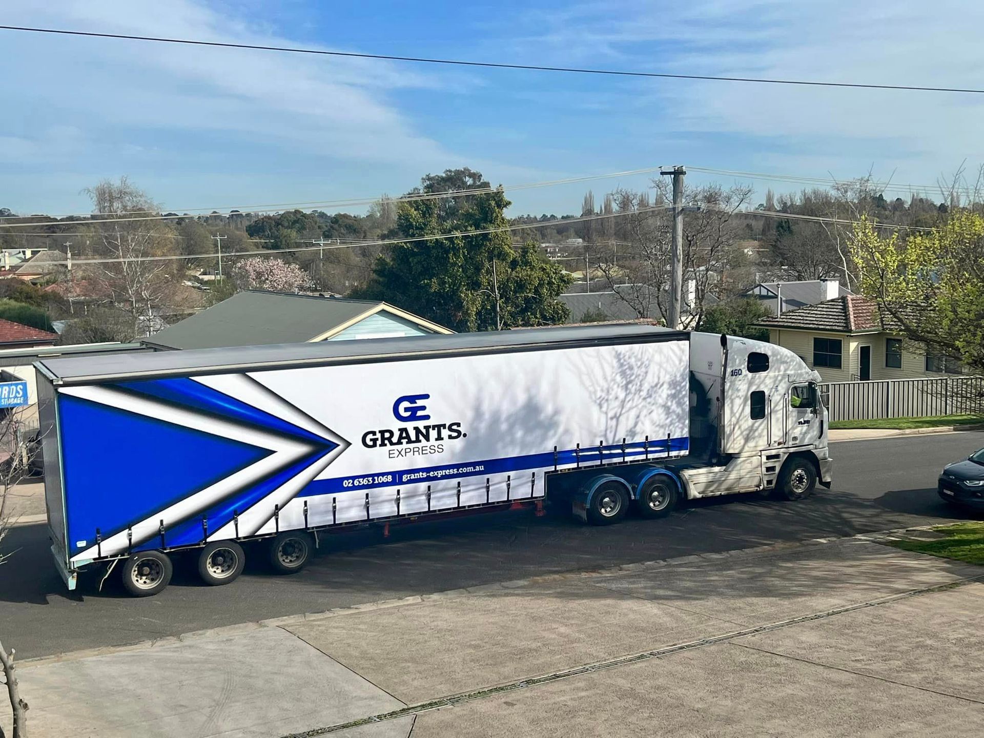 White Suv is Parked in a Parking Lot Next to a White Truck — Grants Express in Orange, NSW