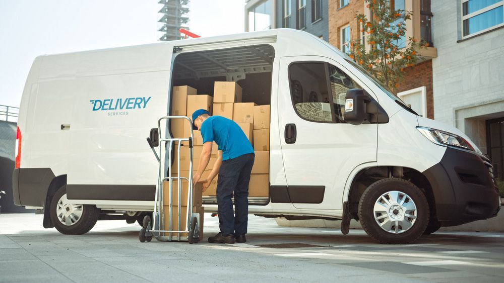 Delivery Man is Loading Boxes Into a Delivery Van — Grants Express in Pemulwuy, NSW