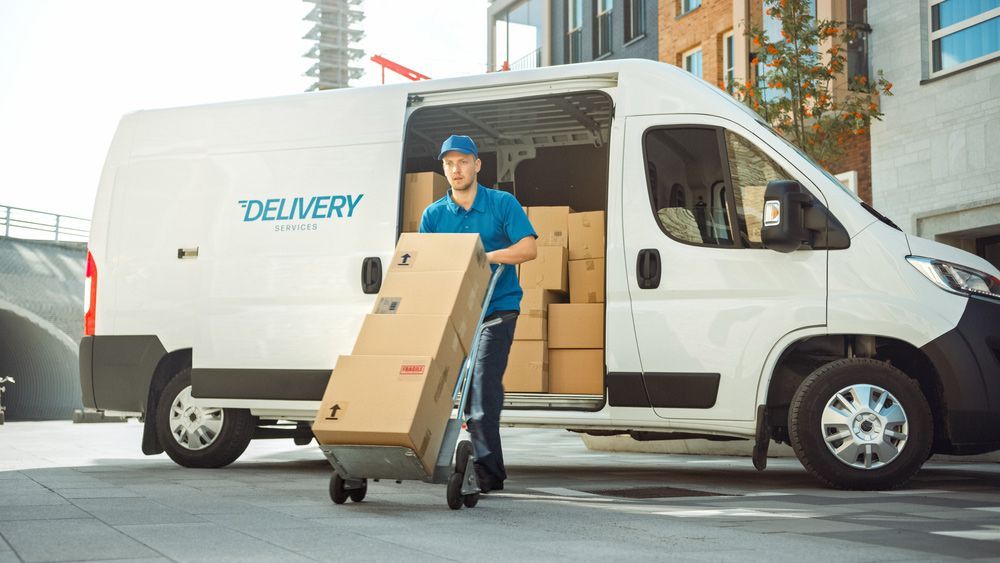 Delivery Man is Loading Boxes Into a Delivery Van — Grants Express in Blacktown, NSW