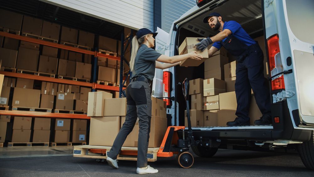 Man and a Woman Are Shaking Hands While Loading Boxes Into a Van — Grants Express in Smithfield, NSW