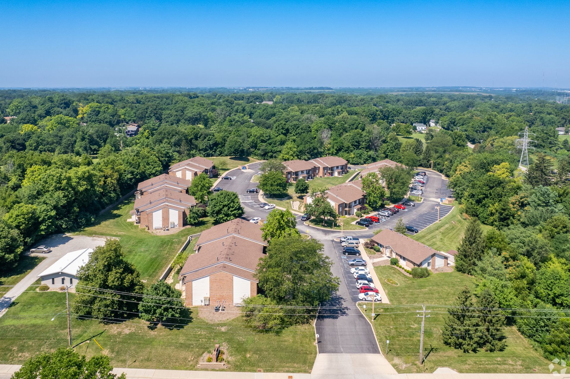 An aerial view of a residential area with lots of trees and buildings.