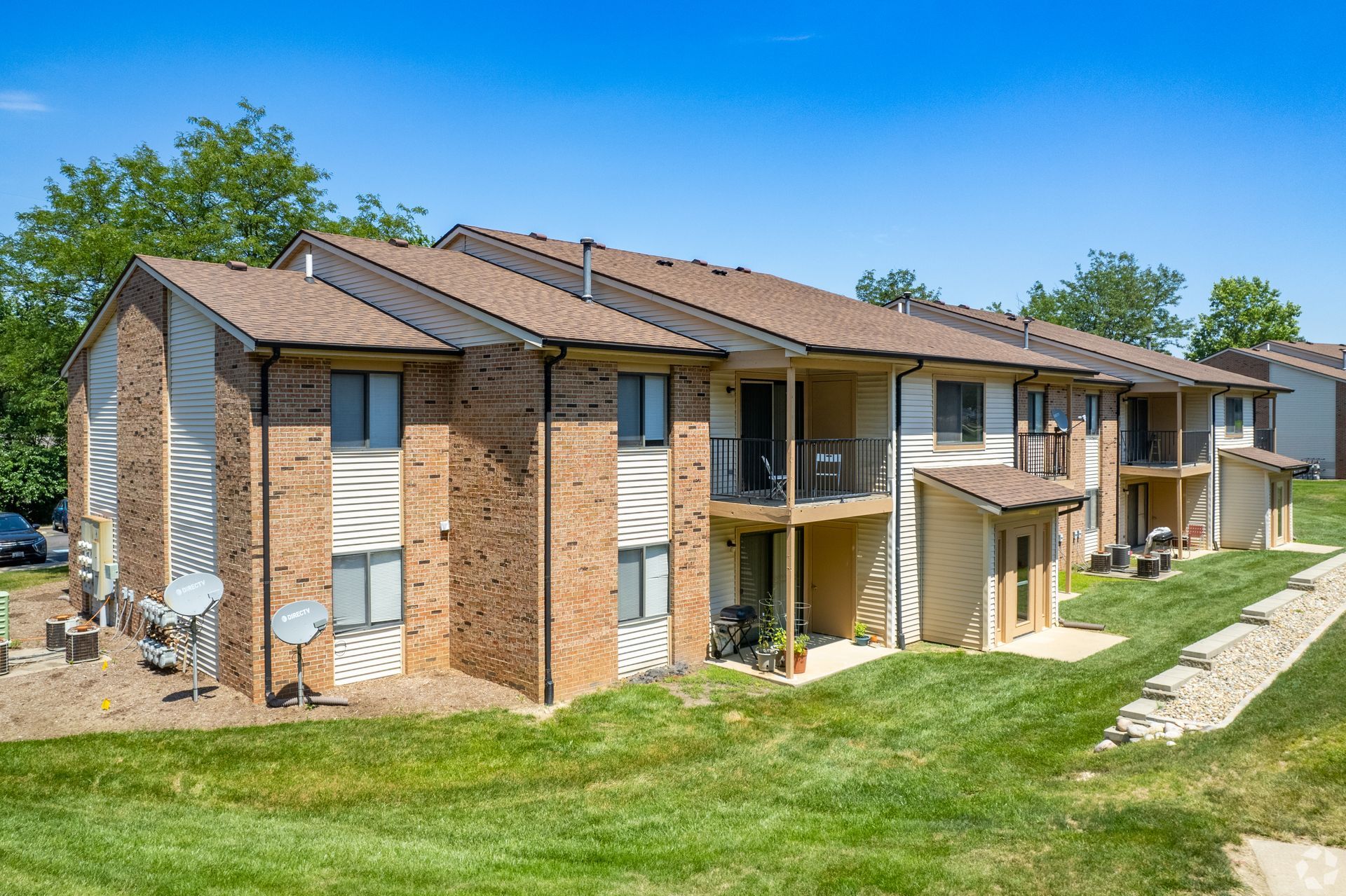 A large brick apartment building with a lot of windows and balconies.