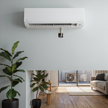 White wall-mounted air conditioner above a sunlit living room with potted plant and sofa