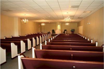 Rows of purple benches in an empty church
