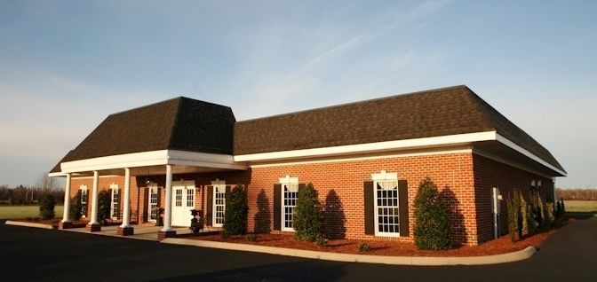 A large brick building with a brown roof and white trim