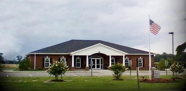 A large brick building with a brown roof and white trim