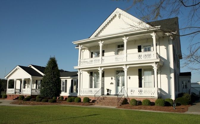 A large brick building with a brown roof and white trim