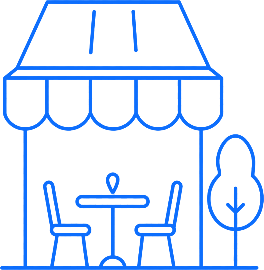Blue line icon of a small café with awning, outdoor table and chairs, and a tree.