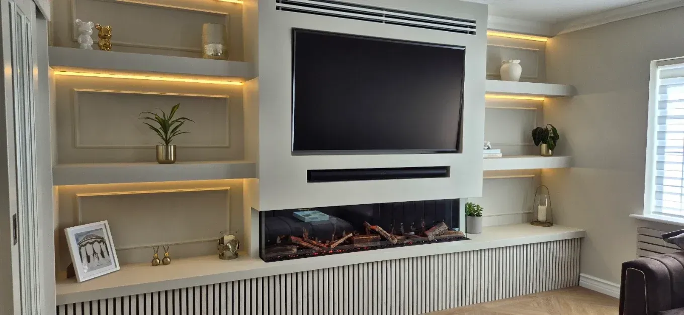 Modern living room with dark sofa, coffee table, and floor-to-ceiling windows overlooking greenery